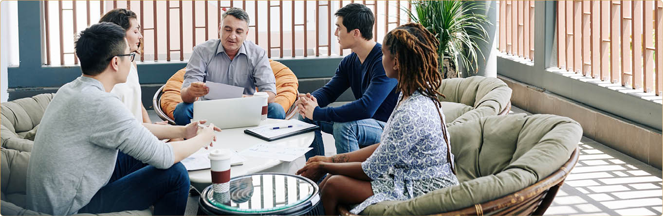Multi-ethnic business team meeting at office lounge area to discuss results of work and development plan